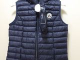 a blue vest with a hood on it hanging on a hanger