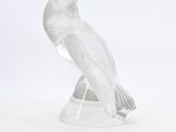 clear glass figurine of a bird on a clear base