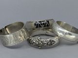 three silver rings with black stones on them sitting on a table