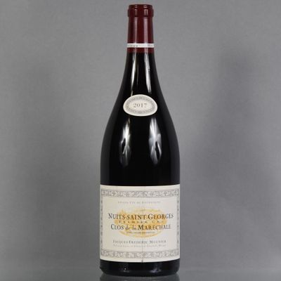 a bottle of wine sitting on top of a table next to a glass