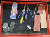 a red tool box with tools in it on a table