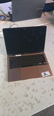 a laptop computer sitting on a table in a room