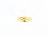 a yellow gold ring with a single diamond in the center