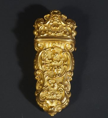 a gold plated wall hanging with a lion head on it