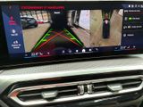 the view of a car ' s rear view camera from the driver ' s seat
