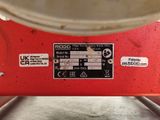 a close up of a red machine with stickers on it