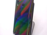 the back view of a phone with a multicolored design on it