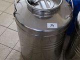 a large metal container sitting on the floor next to a blue bin