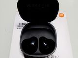 an image of a pair of black earphones in a box