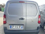 a silver van that is parked in a parking lot