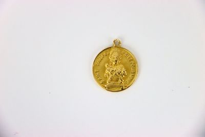 a close up of a gold coin on a white surface