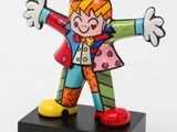 brightly colored clown figurine on black base on white background
