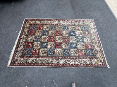 a rug on the floor next to a pair of scissors