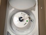 a box with a toilet inside of it that has the lid open
