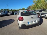 many cars parked in a parking lot with trees in the background