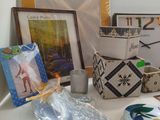 a table with many items on it and a picture on the wall
