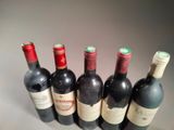 several bottles of wine are lined up in a row