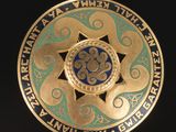 a gold and blue medallion with a star on it