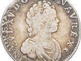 gros plan d'une pièce de monnaie sur laquelle figure un visage de femme