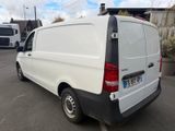 the back of a white van parked in a parking lot