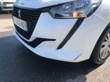 the front end of a white car parked in a parking lot