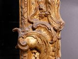 an antique gold mirror with ornate carvings and a gold frame