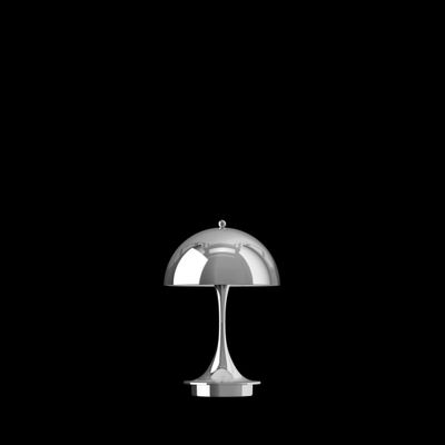 an image of a silver table lamp on a black background