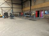 a large warehouse with a lot of chairs and tables in it