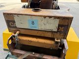 a small machine that is sitting on the side of the road