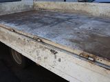 a dirty truck bed sitting in the back of a truck