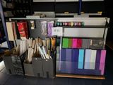 a lot of office supplies on the shelves in the room