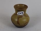a small brown vase with a number on it