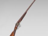 a rifle with a wooden barrel and a wooden handle