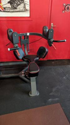 a machine that is sitting on the floor in front of a red wall