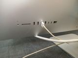 a close up of a computer with a white cord connected to it