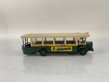 a toy bus that is sitting on a white surface
