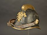a helmet that has a horse on it on a stand
