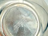 a close up of a silver vase on a table