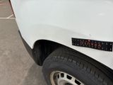 the back end of a white truck with a sticker on it ' s bumper