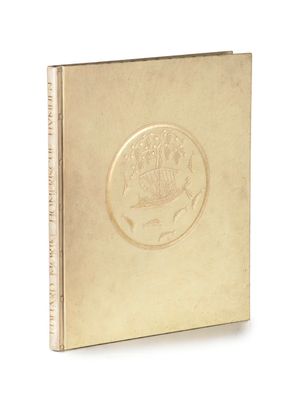a gold plated book with a picture of a ship on it