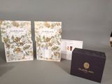 two boxes of guerlain perfume sitting next to each other on a table