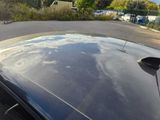 a reflection of the sky on the hood of a car