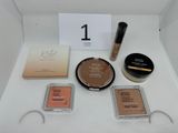 a white box with various cosmetics items on top of it