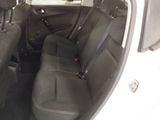 the back seats of a white car with black seats in it