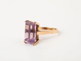 a close up of a ring with an amethorate stone in it