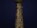 an ancient bronze statue of a woman holding a bowl on her head