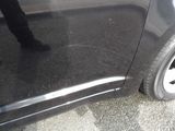 a close up of a car ' s tire with a person standing next to it
