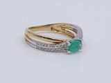 two gold and silver rings with a green stone and diamonds