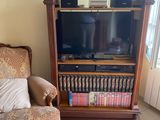 a couch and a chair in a living room with a television