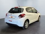 the back of a white car is parked in a room